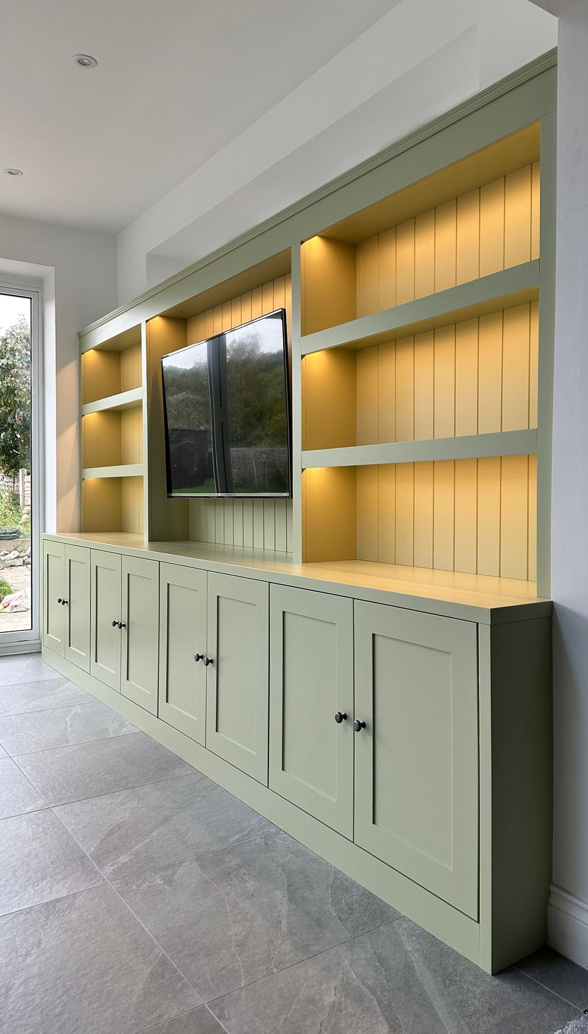 Bespoke green fitted media wall with integrated lights in Kent